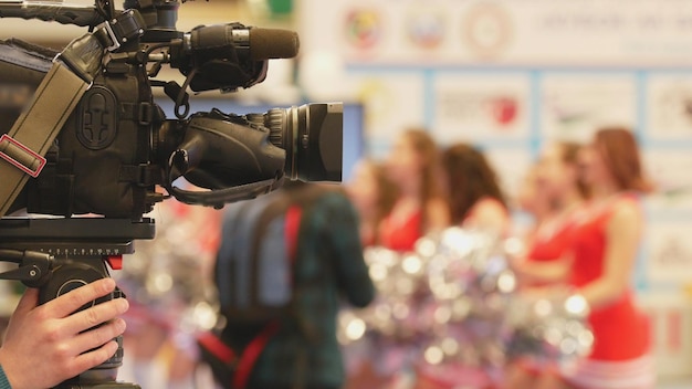 Reporter recording ambient sound with a handheld recorder
